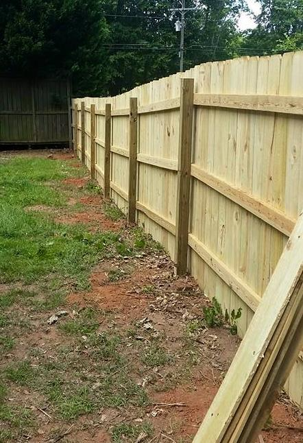 Dog-eared privacy fence with visible support posts
